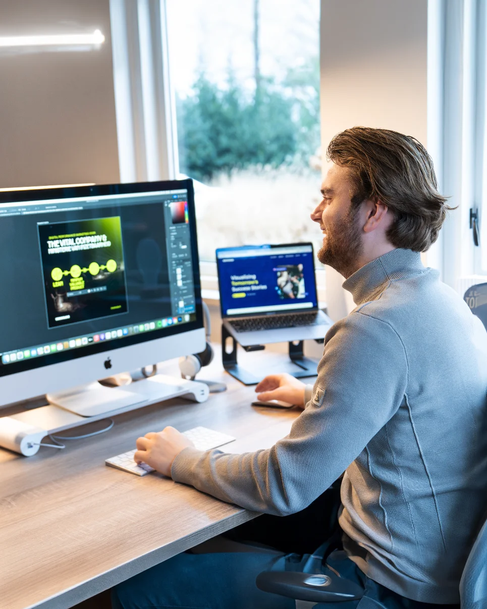 Een marketeer van Innomads aan het werk achter een iMac